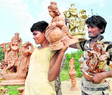 Vendors sell idols of Lord Krishna on the eve of Janmashtami in Patiala on Sunday