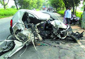 The mangled heap of the car lying on the Bathinda-Dabwali road