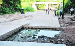 The construction work of the concrete road in Industrial Area, Phase I, Chandigarh, under the railway overbridge has been pending for over four months.