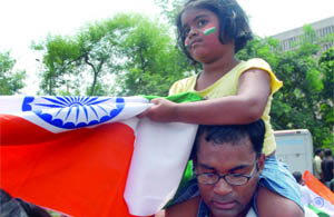 A child atop her fathers shoulders at the Ramlila Ground in New Delhi.