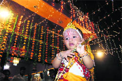 A child dressed as Lord Krishna in front of Geeta Satsang Bhawan Mandir on the occasion of Janmashtami in Dehradun on Monday