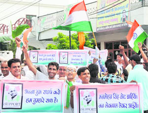 Supporters of Anna Hazare protest outside MP Arvind Sharmas residence in Karnal on Monday