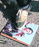 Rebels trample a picture of  Gaddafi. 