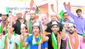 Playing their part: Members of the Bharat Gaurav Sanstha stage a dharna in support of Anna Hazare in front of the MC office in Jalandhar on Monday