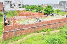 A view of the construction work in progress on a road leading towards Kaushalaya Kundan Progressive Medical Hospital in Ludhiana