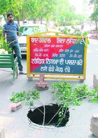 A part of the road that caved in near the Civil Surgeons office in Ludhiana on Monday