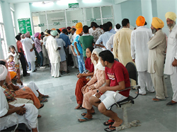 Patients queue up to get prescription slips at the new OPD block in the Civil Hospital, Bathinda, on Tuesday