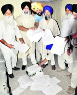 Independent candidates, led by Hardeep Singh, show the bundle of forms that were brought to the DAC in Phase 1, Mohali, to get voters registered.