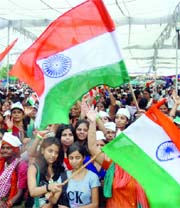 Supporters of the anti-corruption campaign shout the anti-UPA government slogans at the Ramlila Ground in New Delhi on Tuesday.