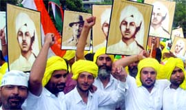 Supporters of Anna Hazare carry placards at the Ramlila Ground in New Delhi on Tuesday.