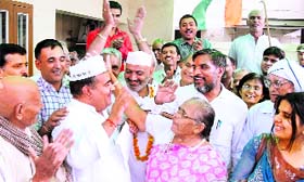 Congress MP Jitender Singh Malik (wearing Anna cap) meets protesters outside his house in Sonepat, on Tuesday.