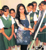 Amanat Singh shows one of her creations to schoolgirls in Shimla.