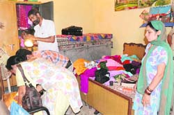 A team of forensic experts examine the scene of crime at the house of Janaki Devi, where two robbers robbed a woman of cash and jewellery at gun-point.