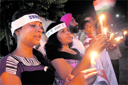 Supporters of Anna Hazare take out a candlelit march outside Punjab Agricultural University in Ludhiana