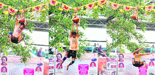 A Govinda tries to break Dahi Handi during Janmashtami celebrations in Mumbai. 