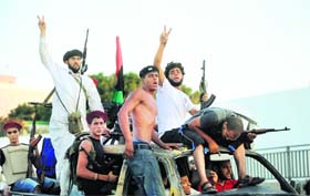 VICTORY LAP: Libyan rebels celebrate as they overrun Muammar Gaddafis compound in Tripoli on Tuesday