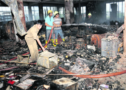 Firemen douse flames on the top floor of the Punjab National Bank building in Sector 17, Chandigarh, on Wednesday