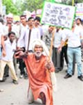 An old man raises slogans during a protest against corruption outside MP Arvind Sharmas house in Karnal 