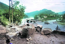 A vehicle damaged in a landslide that blocked the Mandi bypass on Wednesday.