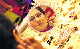 Jewelled Fashion: One of the visitors taking a pick at a jewellery stall at Fashion Shopping Fiesta, an exhibition of designer wear, Jalandhar on Wednesday