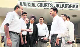 Lawyers engage in a conversation as no work was observed at the district and sessions court on Tuesday