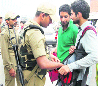 CRPF jawans search two youths at Lal Chowk in Srinagar on Wednesday following an increase in infiltration bids from across the LoC. 