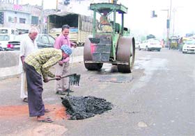 Patchwork being undertaken at Jagraon Bridge in Ludhiana on Wednesday