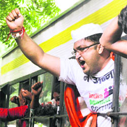A supporter of Anna Hazare shouts slogans after being arrested outside Prime Minister's residence in New Delhi 