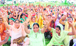Members of Asha Workers Union, Punjab, protest against the Health Minister in Amritsar on Thursday