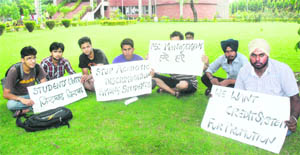 Members of the Students for Society, a student body, protest outside the administrative block at the PEC University of Technology. 