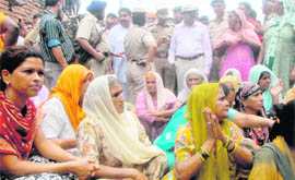 Kaimbwala residents block the road to the village to stop officials from carrying out a demolition drive of illegal structures at the village 