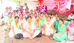 Contractual multipurpose health employees stage a protest outside the Civil Hospital in Ludhiana on Thursday. 