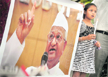 A girl holding a candle expresses solidarity with Anna Hazare in Ludhiana. 