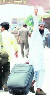 A Pakistani prisoner waves while crossing over to his homeland at Attari on Thursday. He was one of the seven prisoners repatriated to Pakistan by India. Of those let off, four were released from Jammu and Kashmir, two from Amritsar and one from Tihar Jail. 