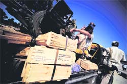 Libyan rebels seize boxes of ammunition hidden by Gaddafis forces in the a forest near Tripoli.