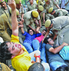 Delhi policemen take away supporters of anti-corruption activist Anna Hazare during a protest outside the residence of Congress party general secretary Rahul Gandhi in New Delhi on Friday. 
