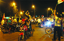 Supporters of anti-corruption activist Anna Hazare on bikes block the road near KG Marg in Connaught Place, New Delhi, on Friday night.