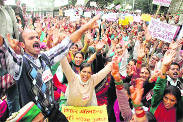 Activists of the Himachal Kisan Sabha raise slogans in support of their demands outside the Vidhan Sabha in Shimla on Friday.