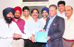 Mayor Rakesh Rathour signs an agreement of lease deed for alloting a land for the hand-tools cluster to its chairman Gautam Kapoor in Jalandhar on Friday.