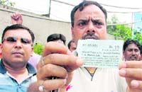 Anilesh Mishra, convener of the investor cell of the BJP, shows a parking slip of the contractor in Ludhiana