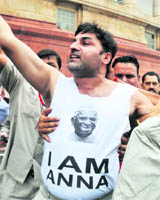 Anna supporter Manjit Singh being taken away from the Parliament complex by security personnel in New Delhi