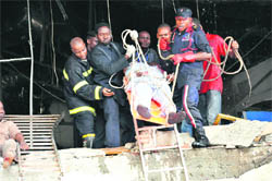 Rescue workers evacuate a wounded man from the UN building of the Nigerian capital Abuja on Friday. 