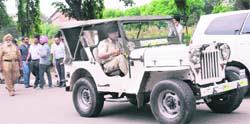 A police official drives off in a jeep impounded at Panjab University