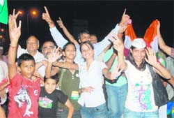 Thrilled supporters of Anna Hazare celebrate after Parliament agreed, in principle, to his key demands, in Chandigarh