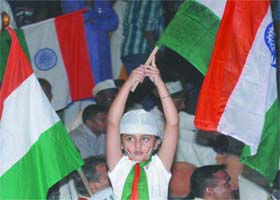 A child carries a Tricolour during the anti-corruption campaign at the Ramlila Maidan in New Delhi on Saturday