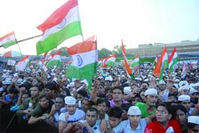 Supporters of Anna Hazare celebrate the victory at the Ramlila Maidan in New Delhi on Saturday