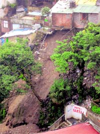 A landslide poses a threat to residents of Ambedkar Colony in Mussoorie on Saturday.