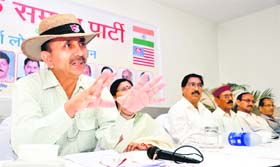 BS Parmar, president of the Sainik Samaj Party, addresses a press conference in Dehradun on Saturday.