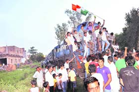 Protesters stop a Panipat-bound train in Rohtak on Saturday