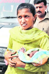 Hospital staff take the newborn baby to Mahavir Dal Hospital in Karnal as the Civil Hospital does not have an incubator